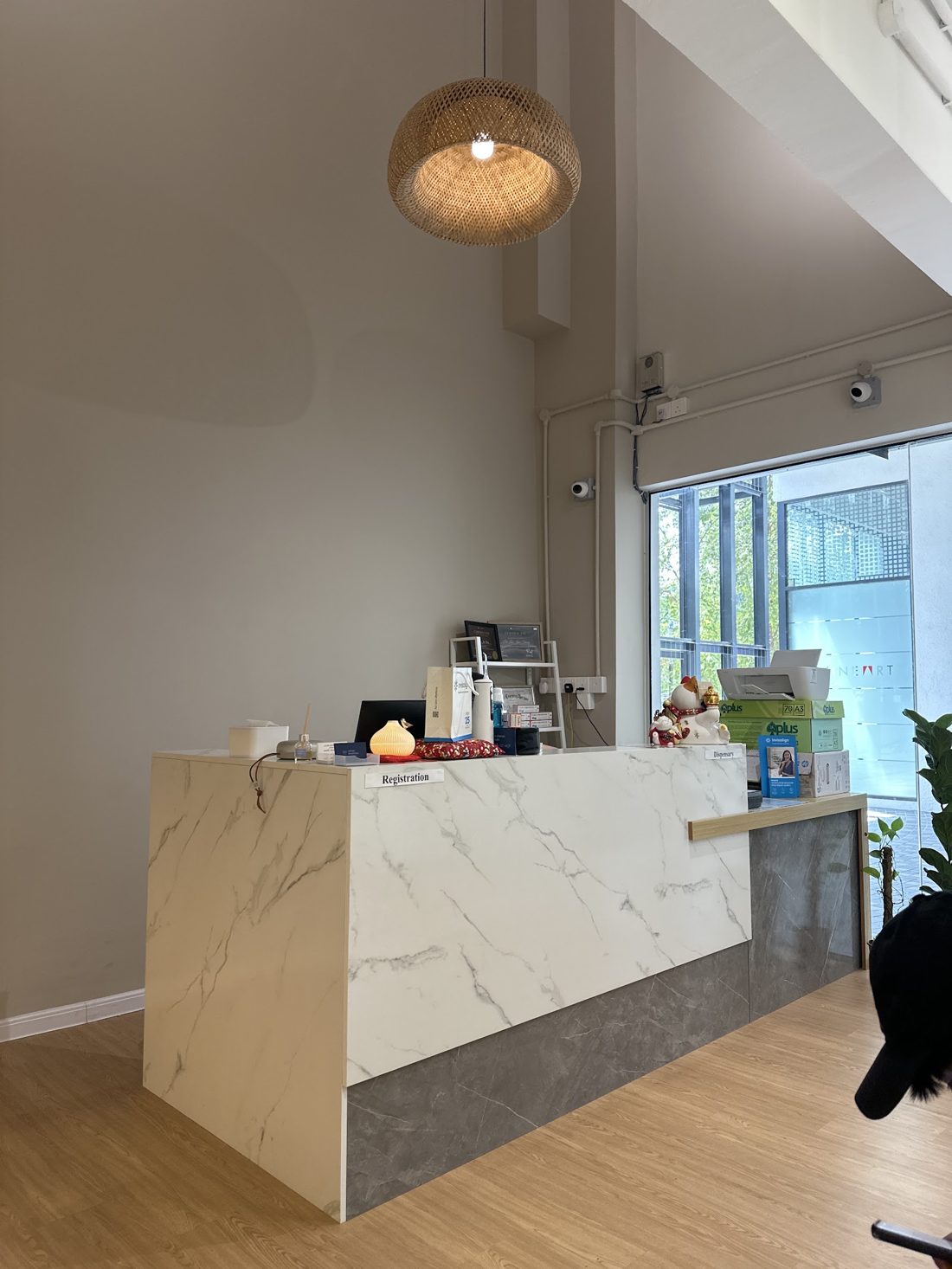 Marble reception counter under a rattan lamp